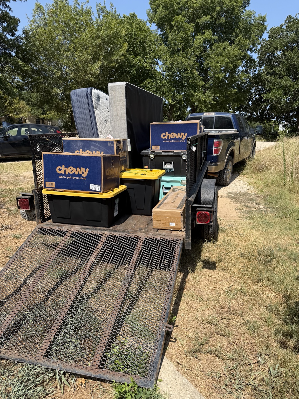 Household items organized on a utility trailer